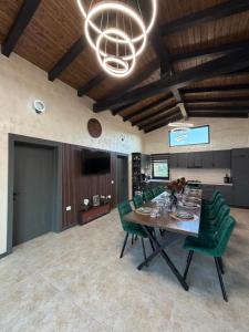 a dining room with a table and green chairs at Cindrel Chalet Jina in Jina
