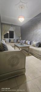 a living room with two beds and a couch at Appartement à louer wadie in Fnidek