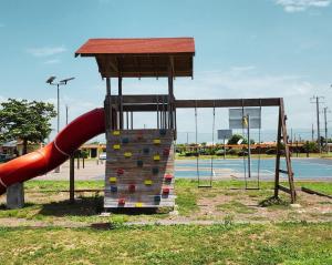 a playground with a slide and a rock wall at Beachfront Ocean View Loft with Beach, Pool and Parking in Portmore