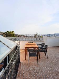 a table and chairs on top of a roof at Dar Al Massir in Chefchaouen