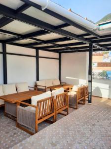 a room with a wooden table and chairs and a tableasteryasteryasteryasteryastery at Dar Al Massir in Chefchaouen