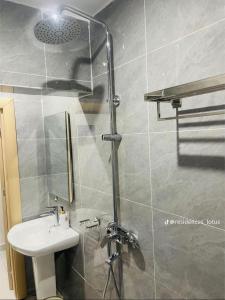 a bathroom with a shower with a sink and a shower at Appart lotus in Cocody +7 photos