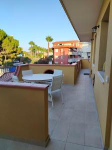 a balcony with a table and chairs on a building at My Sicily apartments in Taormina