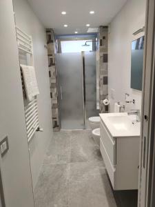 a bathroom with a shower and a toilet and a sink at My Sicily apartments in Taormina