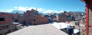 an overhead view of a city with buildings and mountains at Nery Lodging in Huaraz