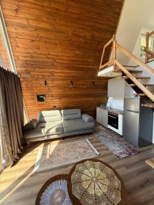 a living room with a couch and a staircase at Villas Çeremi in Maskollatë