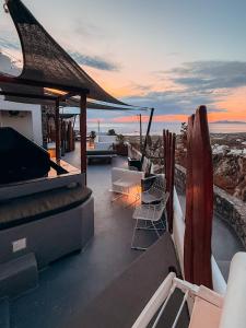 a balcony of a house with a view of the ocean at Lumera Suites in Firostefani +18 photos