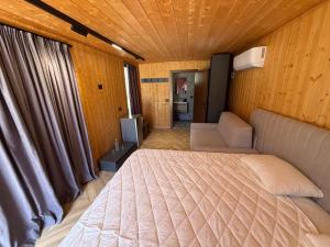 a bedroom with a bed and a television in it at Villas Çeremi in Maskollatë