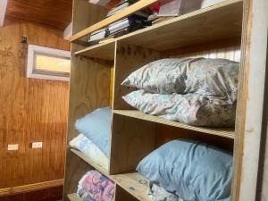 a room with shelves with pillows on them at Alojamiento Halcones in Concepción