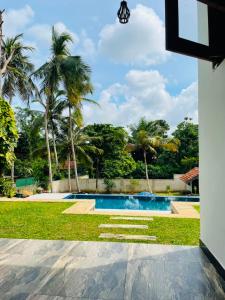 a view of a swimming pool with palm trees at Villa Serandiva in Galle +3 photos