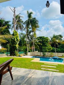 a resort with a swimming pool and palm trees at Villa Serandiva in Galle