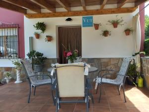 a table and chairs on a patio with potted plants at Ca Blanca in Sorribas