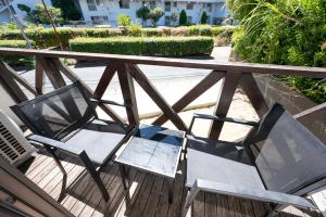 two chairs sitting on a deck on a balcony at Shiokaze Miura Kaigan - 三浦海岸 in Miura +41 photos