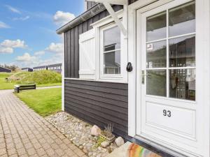 a house with a white door and a bench at 6 person holiday home in Vestervig-By Traum in Vestervig