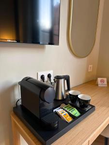 a table with a coffee maker and two cups on it at Malaga Rooms in Málaga