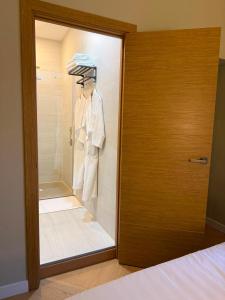 a room with a glass door with a mannequin at Malaga Rooms in Málaga