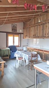 a kitchen with a table and chairs in a room at Casa eclipse in Padilla de Abajo