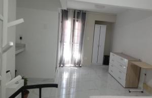 a white room with a dresser and a window at SandritaHouse in Tuluá