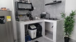 a small kitchen with a sink and a counter at SandritaHouse in Tuluá +3 photos