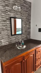 a bathroom counter with a sink and a mirror at Renzo in Deán Funes
