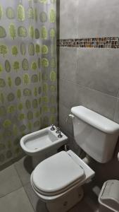 a bathroom with a toilet and a shower curtain at Renzo in Deán Funes