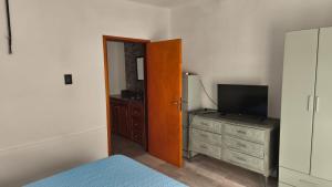 a bedroom with a bed and a television on a dresser at Renzo in Deán Funes