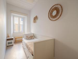 a bedroom with a bed and a mirror on the wall at Nena's Volto, Campiello living in Corfu
