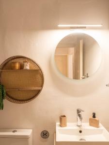 a bathroom with a sink and a mirror on the wall at Nena's Volto, Campiello living in Corfu +36 photos