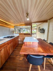 a kitchen with a large wooden table in a kitchen at Las cabañas del Francés in Alto Boquete +6 photos