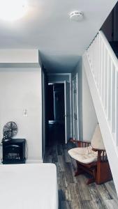 a living room with a staircase and a couch at Wasaga Daze - Unit B in Wasaga Beach