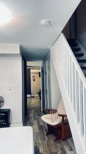 a hallway with a staircase and a stair case at Wasaga Daze - Unit B in Wasaga Beach
