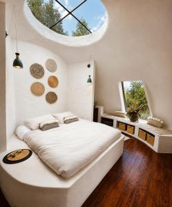 a bedroom with a large white bed and a window at Hichata Breakfast Included in La Calera