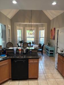 a kitchen with a black island in a room at The Abigail in Braselton