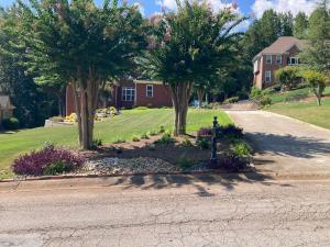 a street with two trees and a house at The Abigail in Braselton +3 photos