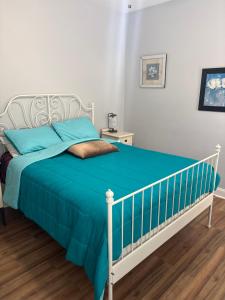 a bedroom with a bed with a blue blanket at The Abigail in Braselton
