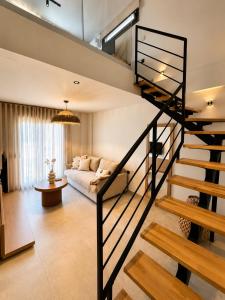 a living room with a spiral staircase in a house at Estia Luxury Suites & Spa in Platamonas