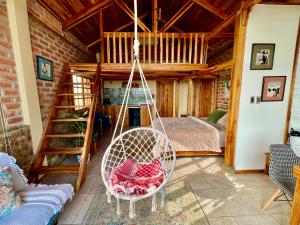 a swing in a room with a bedroom at Nativo Lodge in Playas