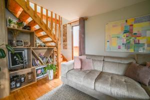 a living room with a couch and a staircase at Country Chic Villa with Pool in Mrginj