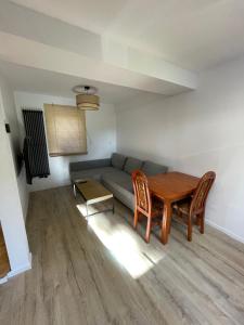 a living room with a couch and a table at Sielankowo in Rożnów