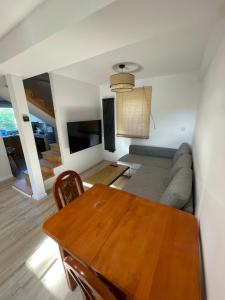 a living room with a table and a couch at Sielankowo in Rożnów