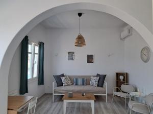a living room with a couch and a table at ALSIDE Apartment in Aegiali