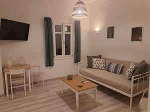 a living room with a couch and a table at ALSIDE Apartment in Aegiali