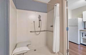 a bathroom with a shower and a toilet at Extended Stay America Select Suites - Charlotte - Tyvola Rd in Charlotte +39 photos