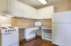 a kitchen with white appliances and a white refrigerator at Extended Stay America Select Suites - Madison - Old Sauk Rd in Madison