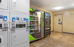 a soda vending machine in a store with soda bottles at Extended Stay America Select Suites - Madison - Old Sauk Rd in Madison