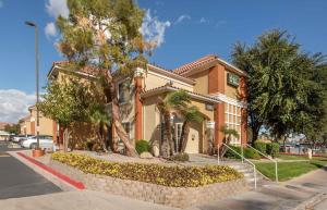 a house with a retaining wall in front of a street at Extended Stay America Select Suites - Phoenix - Mesa - West in Mesa