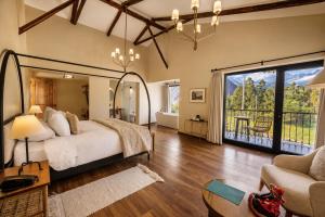 a bedroom with a large bed and a large window at Sierra Sacred Valley in Urubamba