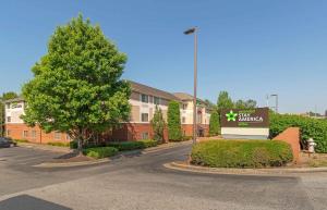 a building with a sign in a parking lot at Extended Stay America Select Suites - Atlanta - Marietta - Wildwood in Atlanta