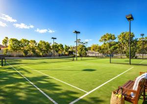a tennis court with two tennis courts at Luxury Renovated Resort Studio Apartment - Oaks Pacific Blue in Salamander Bay