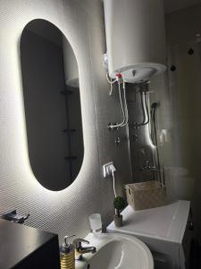 a bathroom with a sink and a large mirror at El Paso Grande in Ledine +25 photos